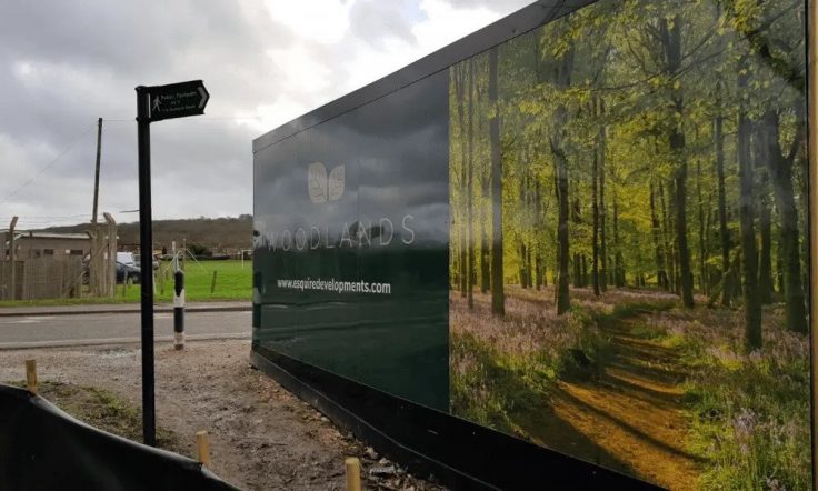 A photo of custom hoarding printing for the Woodlands project