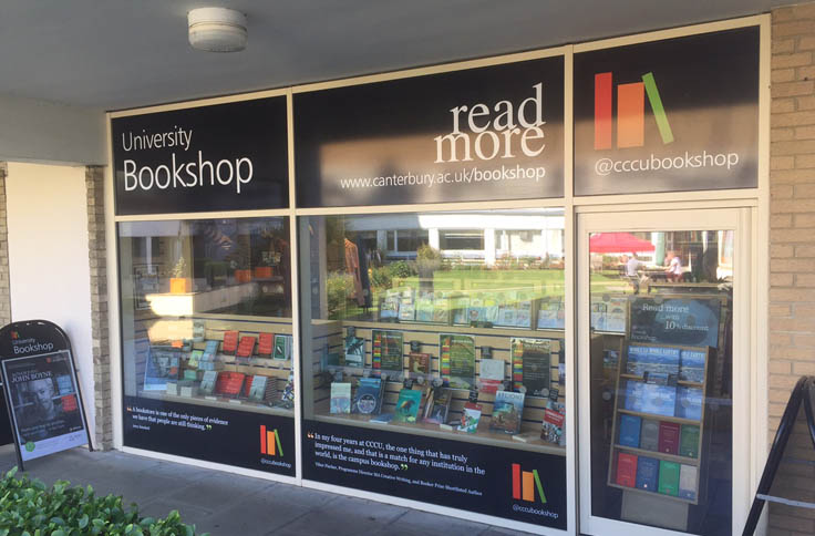 A photo of a front window Signs in a shop