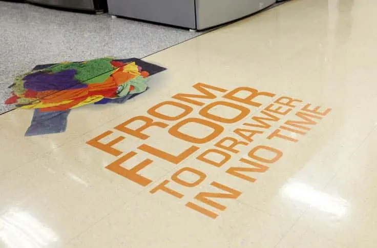 A photo of orange text on printed clear floor vinyl