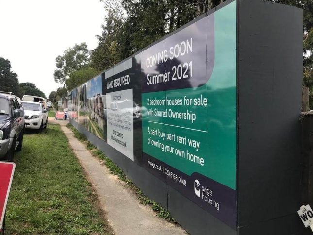A photo of printed site hoarding panels for sage housing