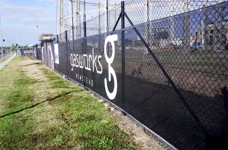 Aero mesh banner fixed to perimeter fencing on construction site