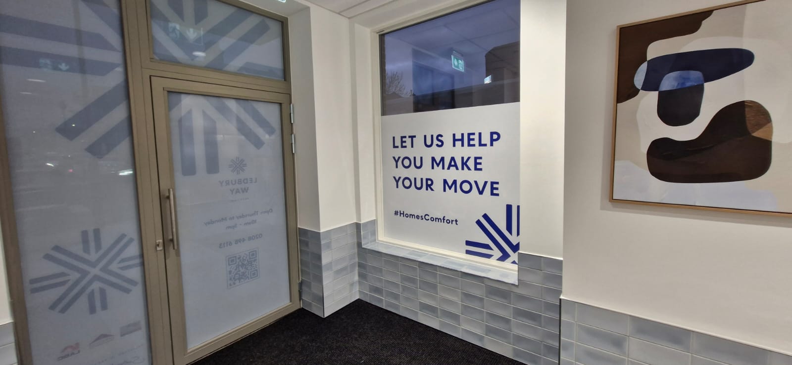 Large format window graphic installation in progress at a commercial office building
