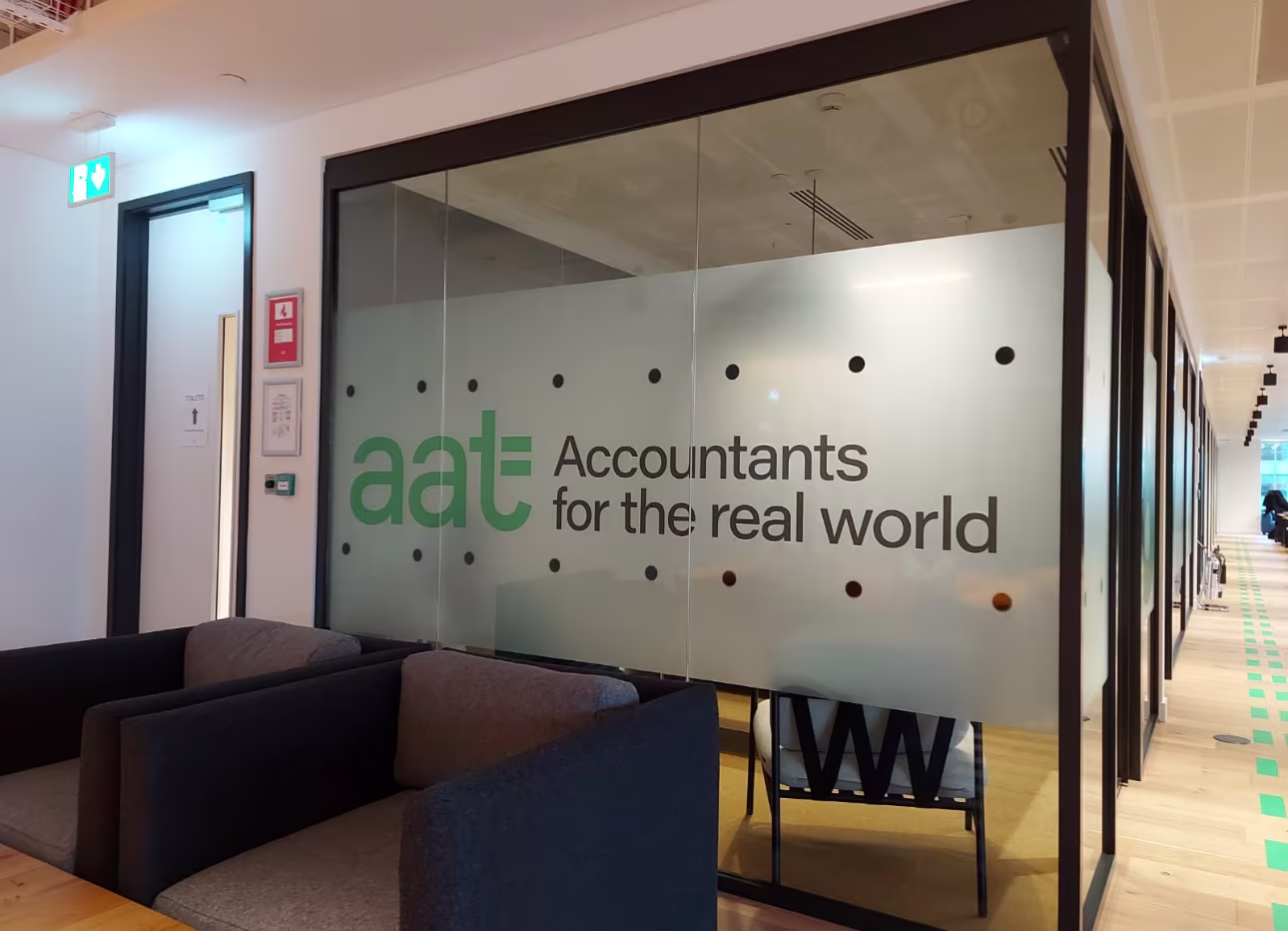Corporate manifestation graphics on office glazing including an AAT Accountants logo