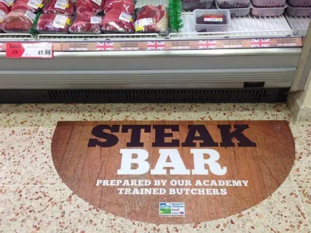 Printed internal floor vinyl reading Steak Bar Prepared By Our Academy in a restaurant