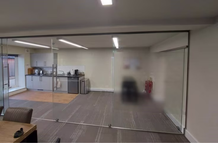 Frosted privacy film applied to meeting room glazed partitions in an office