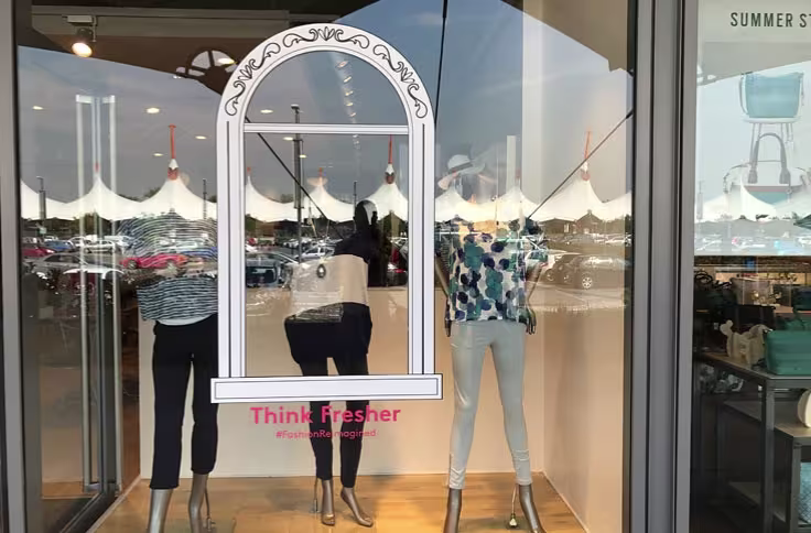 Cut window vinyl with decorative arch design applied to a retail store window