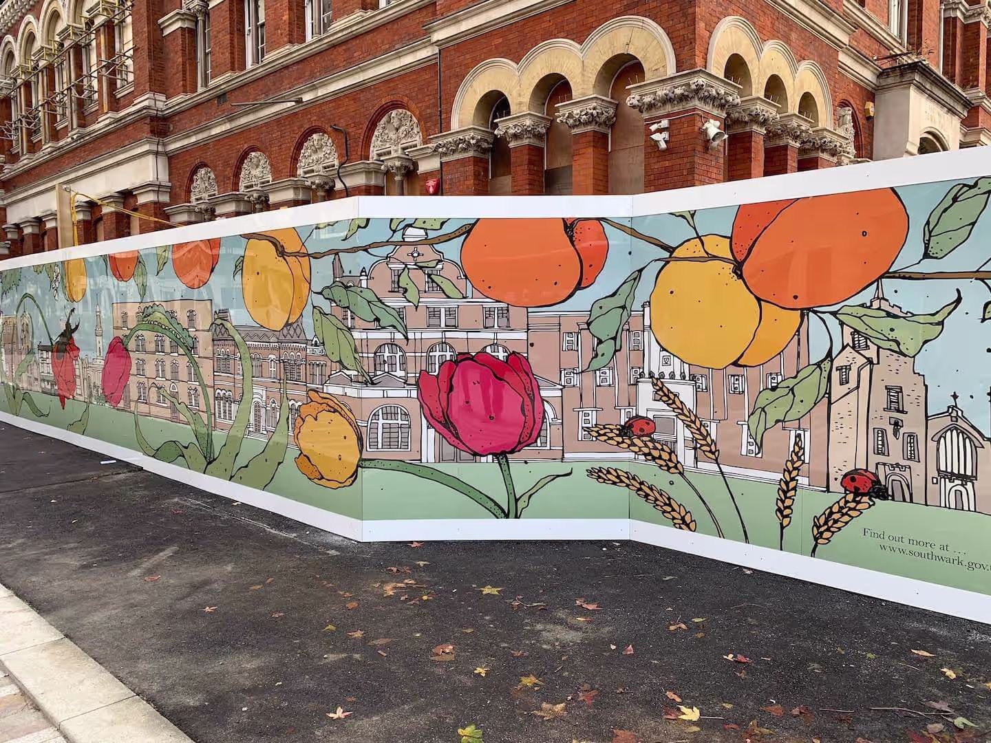 Printed hoarding graphics on Wansey Street, London, colourful community mural design