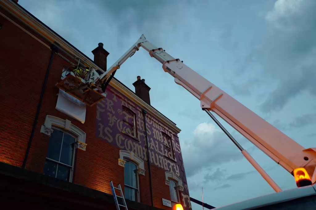 We Are Trade Printers 4 Wide-angle installation shot with cherry picker applying building wrap to a north London pub
